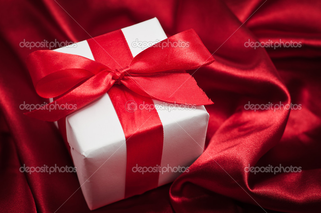 Valentines gift boxes tied with a red satin ribbon bow on red satin  background Stock Photo by ©loriklaszlo 28778717